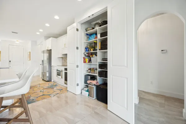 a living room with lots of furniture and white walls