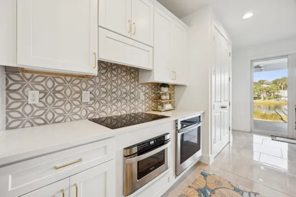 a kitchen with stainless steel appliances granite countertop a sink and a stove