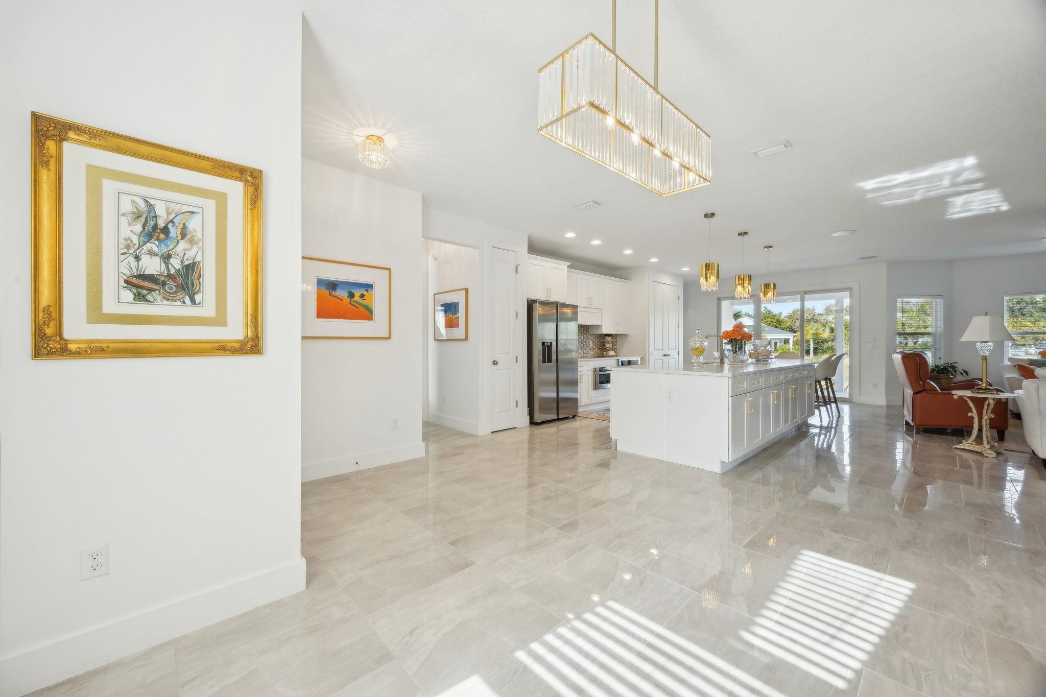 121 Spoonbill Point Court St. Augustine, FL 32080 - Photo 55 of 56 Kitchen featuring open floor plan, white cabinets, hanging light fixtures, a kitchen island with sink, and a breakfast bar area