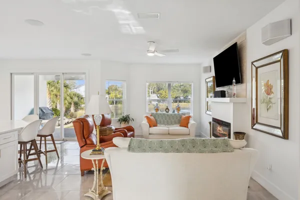 a living room with fireplace furniture and a flat screen tv