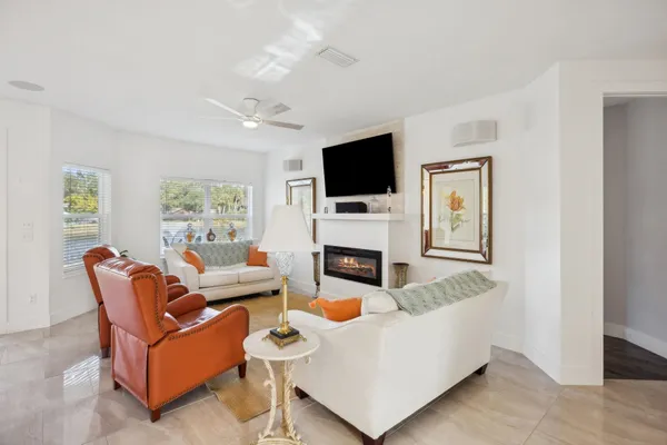a living room with furniture a fireplace and a flat screen tv