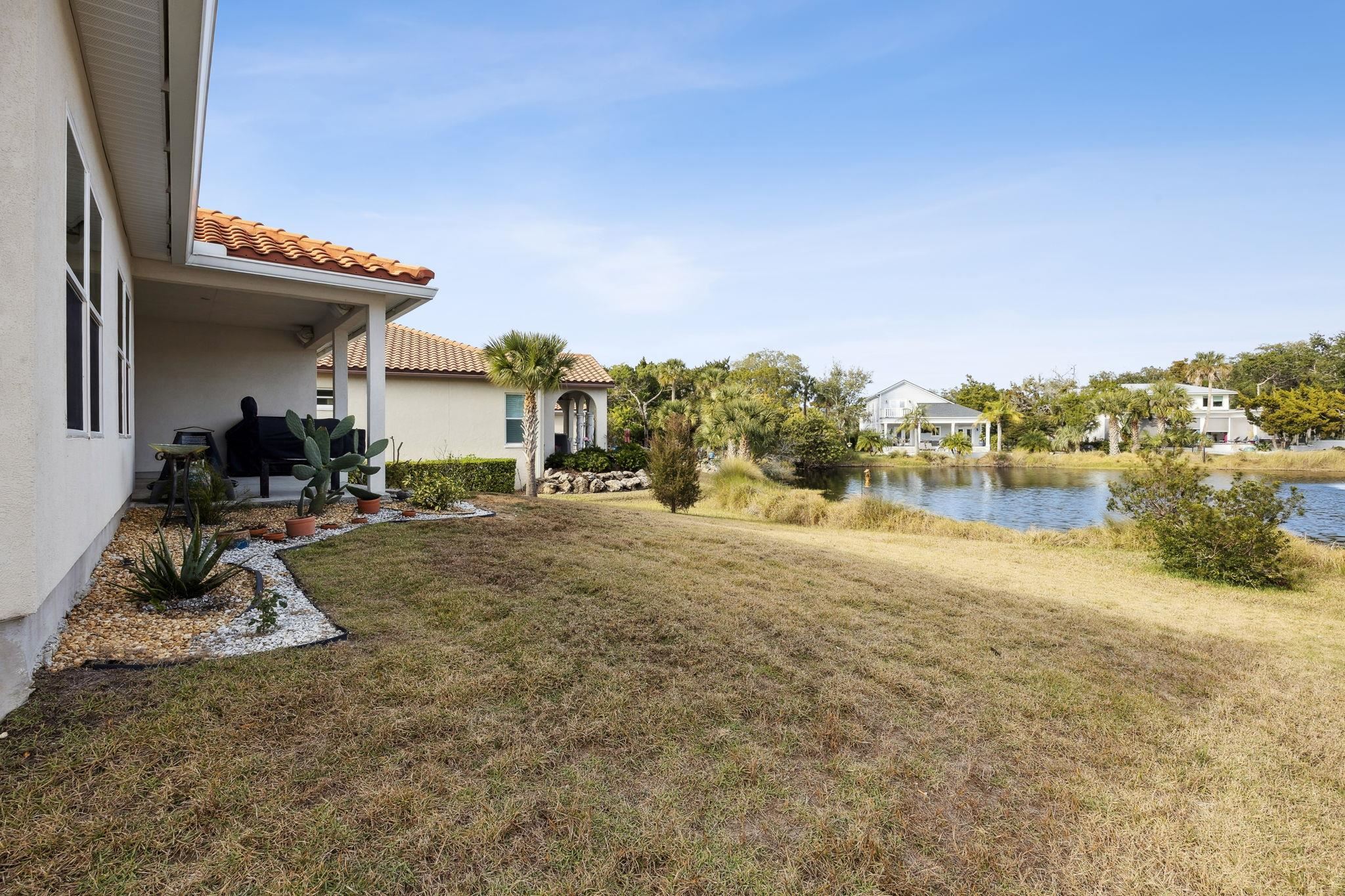 121 Spoonbill Point Court St. Augustine, FL 32080 - Photo 21 of 56 View of grassy yard with a water view and a patio area