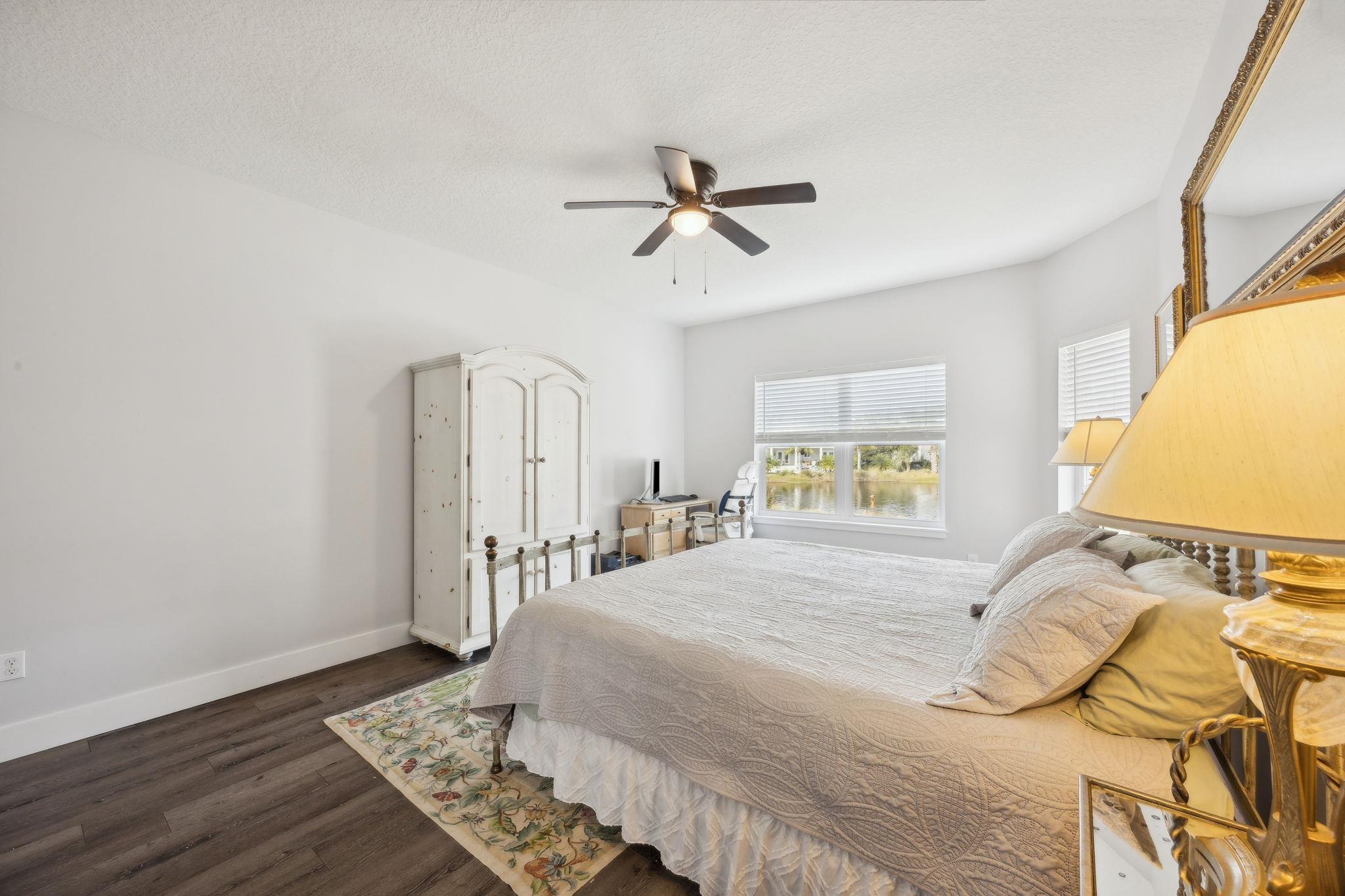 121 Spoonbill Point Court St. Augustine, FL 32080 - Photo 27 of 56 a bedroom with a bed and wooden floor