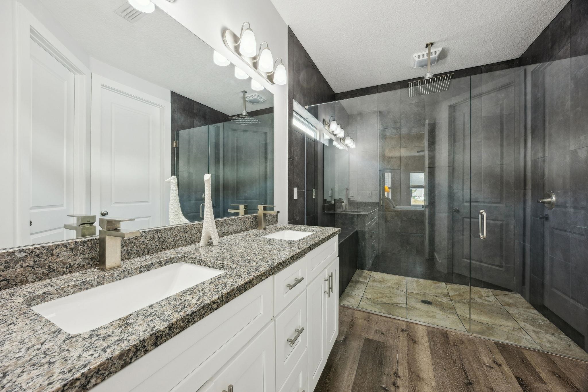121 Spoonbill Point Court St. Augustine, FL 32080 - Photo 29 of 56 a bathroom with a granite countertop double vanity sink and mirror