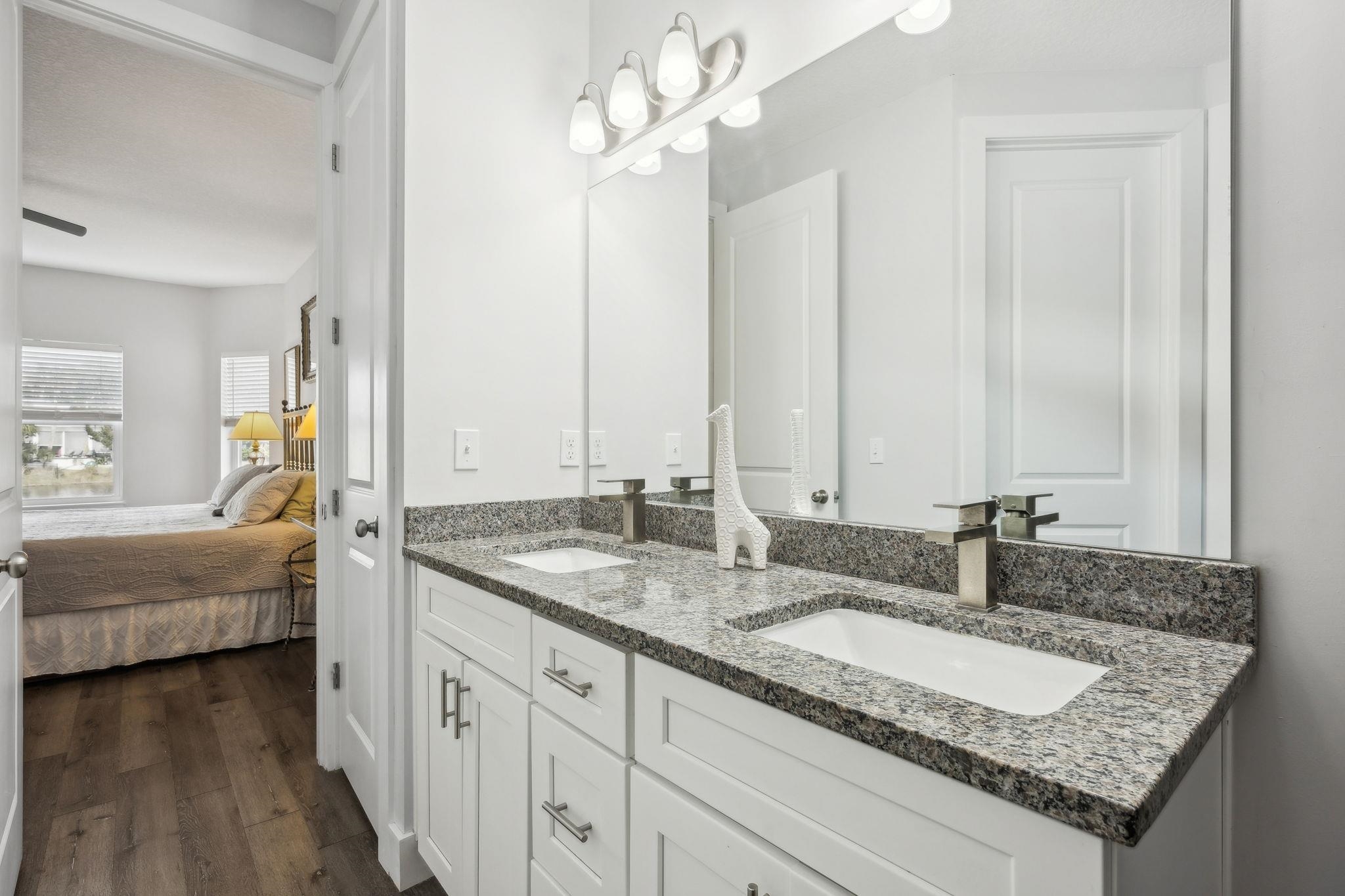 121 Spoonbill Point Court St. Augustine, FL 32080 - Photo 30 of 56 a bathroom with a granite countertop double vanity and a sink