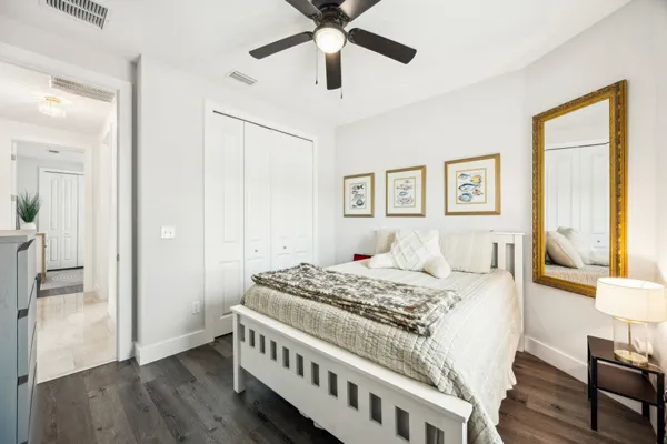 a spacious bedroom with a bed and a chandelier