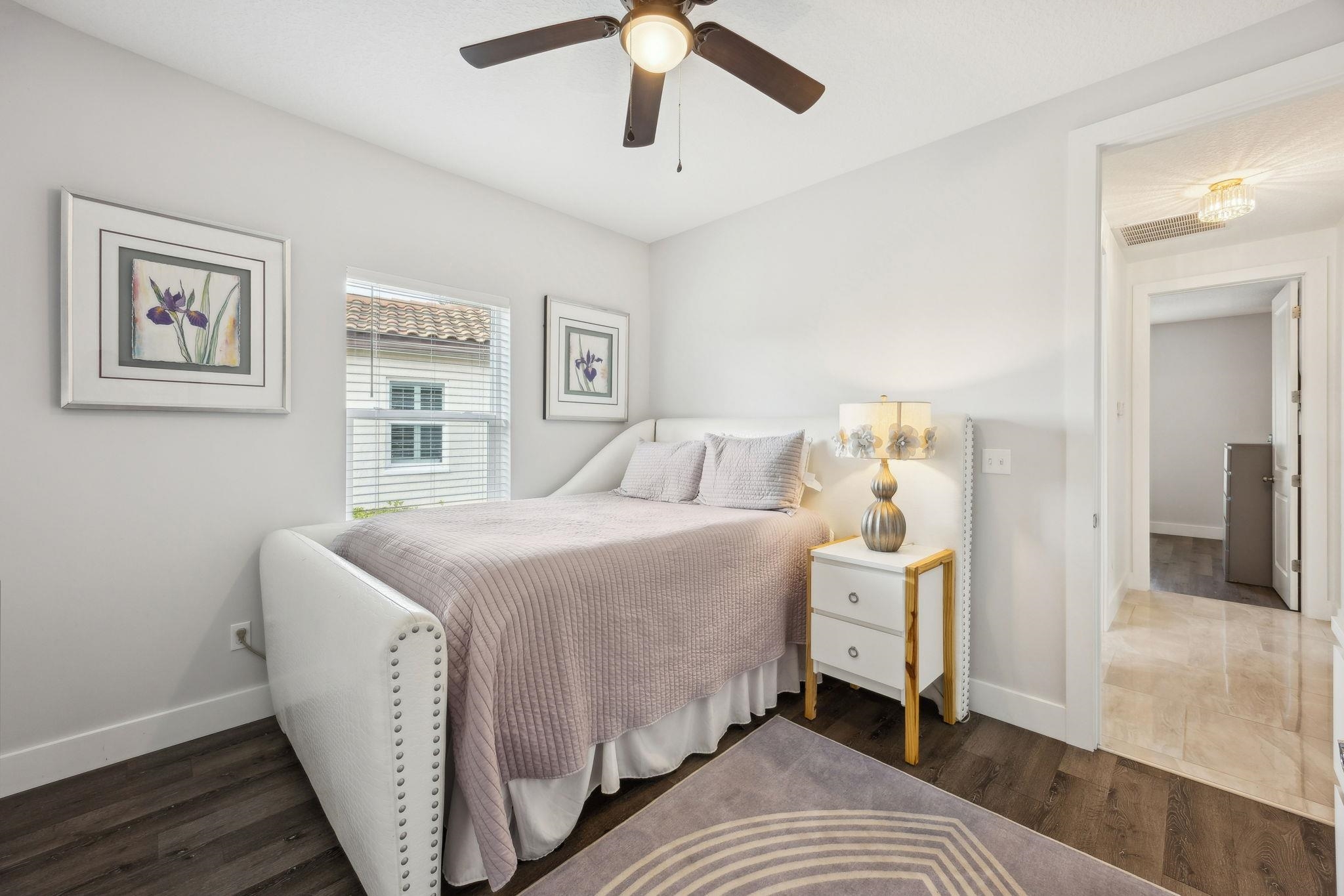 121 Spoonbill Point Court St. Augustine, FL 32080 - Photo 36 of 56 a spacious bedroom with a bed and a chandelier