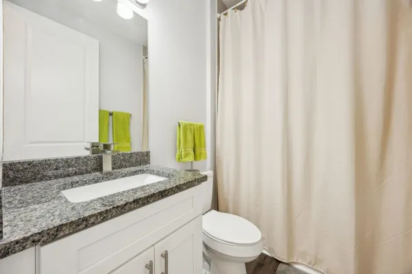 a view of a hallway with wooden floor and furniture