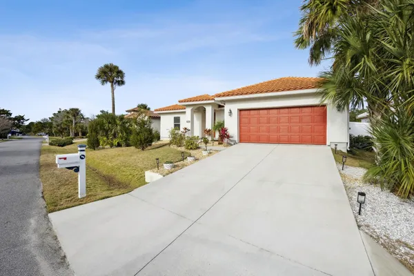 a front view of a house with a yard and a garage