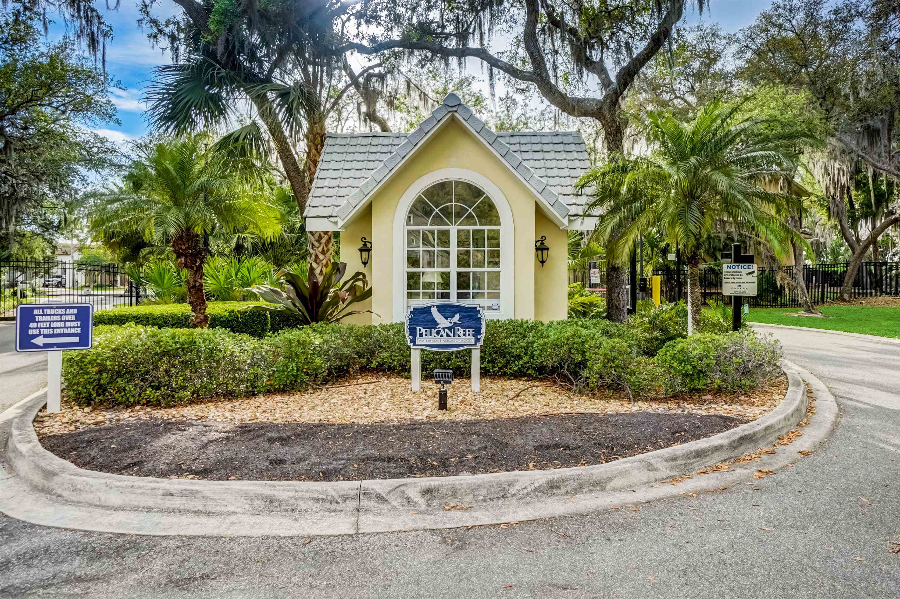 121 Spoonbill Point Court St. Augustine, FL 32080 - Photo 45 of 56 a view of a brick house with a yard and potted plants