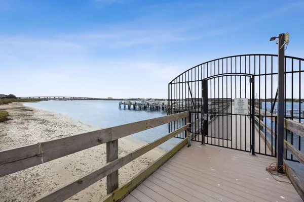 an aerial view of residential houses with outdoor space and lake view