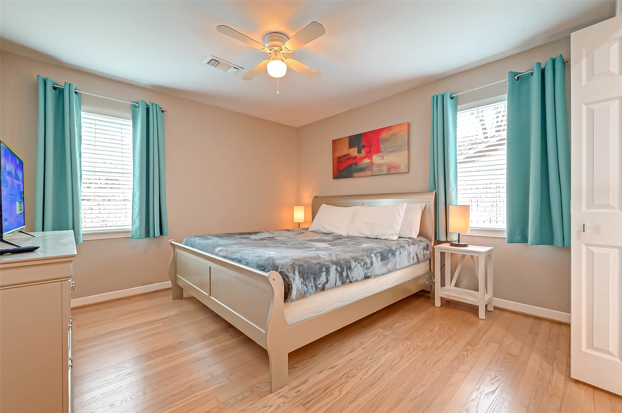 5330 Hialeah Drive Houston, TX 77092 - Photo 21 of 29 a bedroom with a large bed chandelier and a window