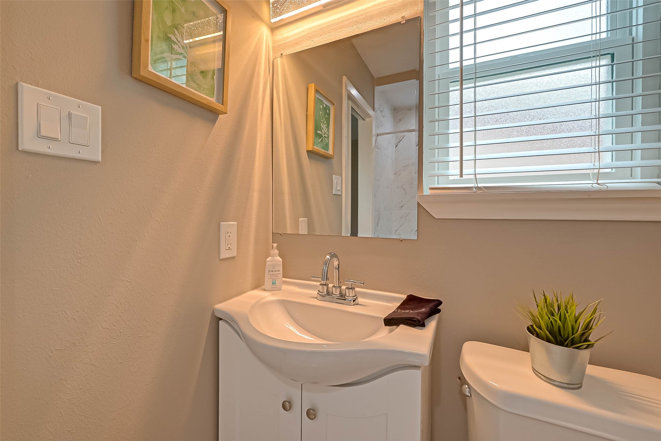 5330 Hialeah Drive Houston, TX 77092 - Photo 25 of 29 a bathroom with a sink a toilet and a mirror