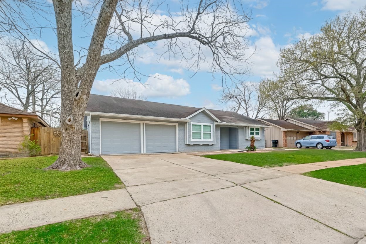 5330 Hialeah Drive Houston, TX 77092 - Photo 28 of 29 a front view of a house with a yard and garage