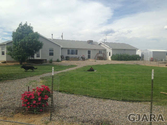 777 R Road Mack, CO 81525 - Photo 1 of 9 a front view of a house with garden