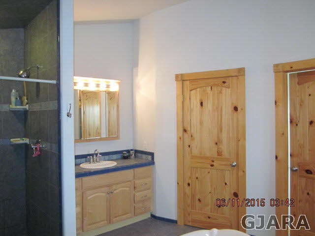 777 R Road Mack, CO 81525 - Photo 9 of 9 a bathroom with a granite countertop sink and a mirror
