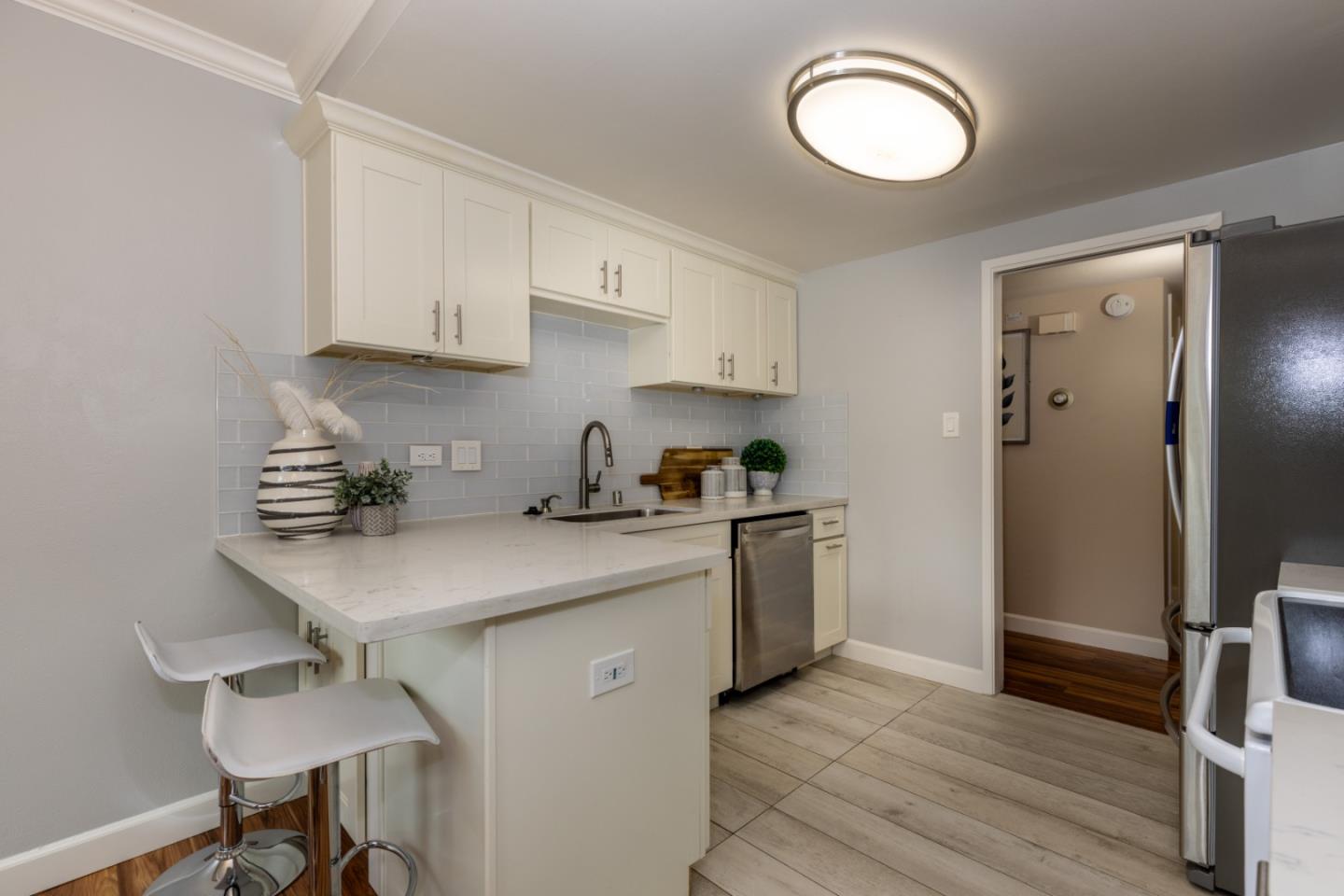 2379 Sharon Road Menlo Park, CA 94025 - Photo 6 of 19 a kitchen with a sink cabinets and wooden floor