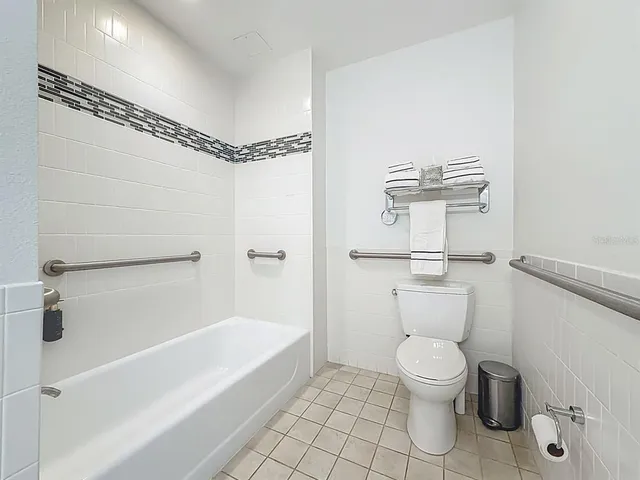 a bathroom with a toilet a sink and a shower