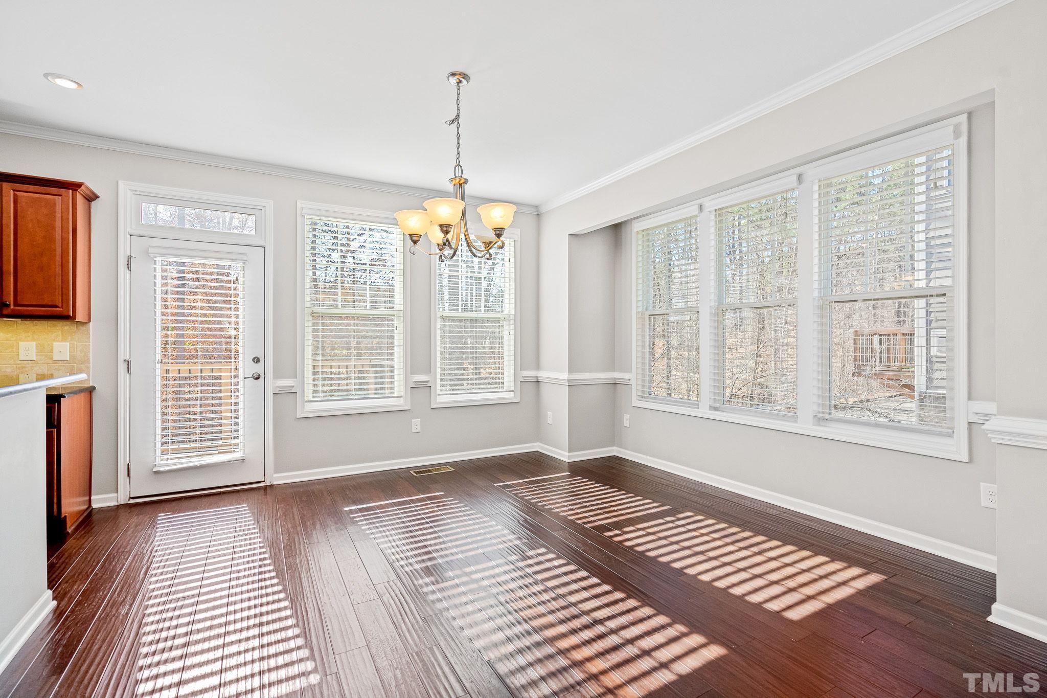 5637 Wade Park Boulevard Raleigh, NC 27607 - Photo 12 of 37 a view of an empty room with wooden floor and a window