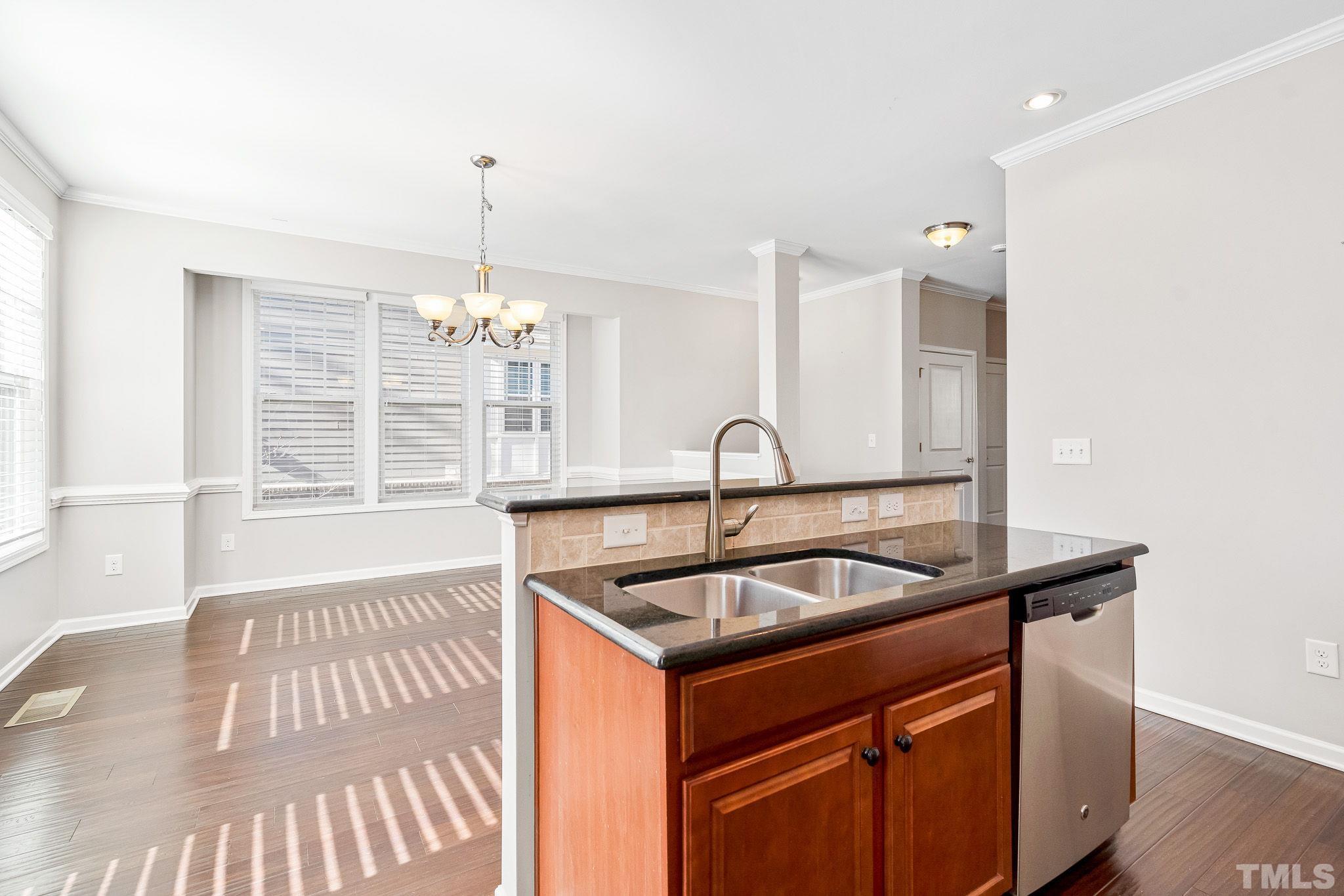 5637 Wade Park Boulevard Raleigh, NC 27607 - Photo 17 of 37 a kitchen that has a sink and a large window