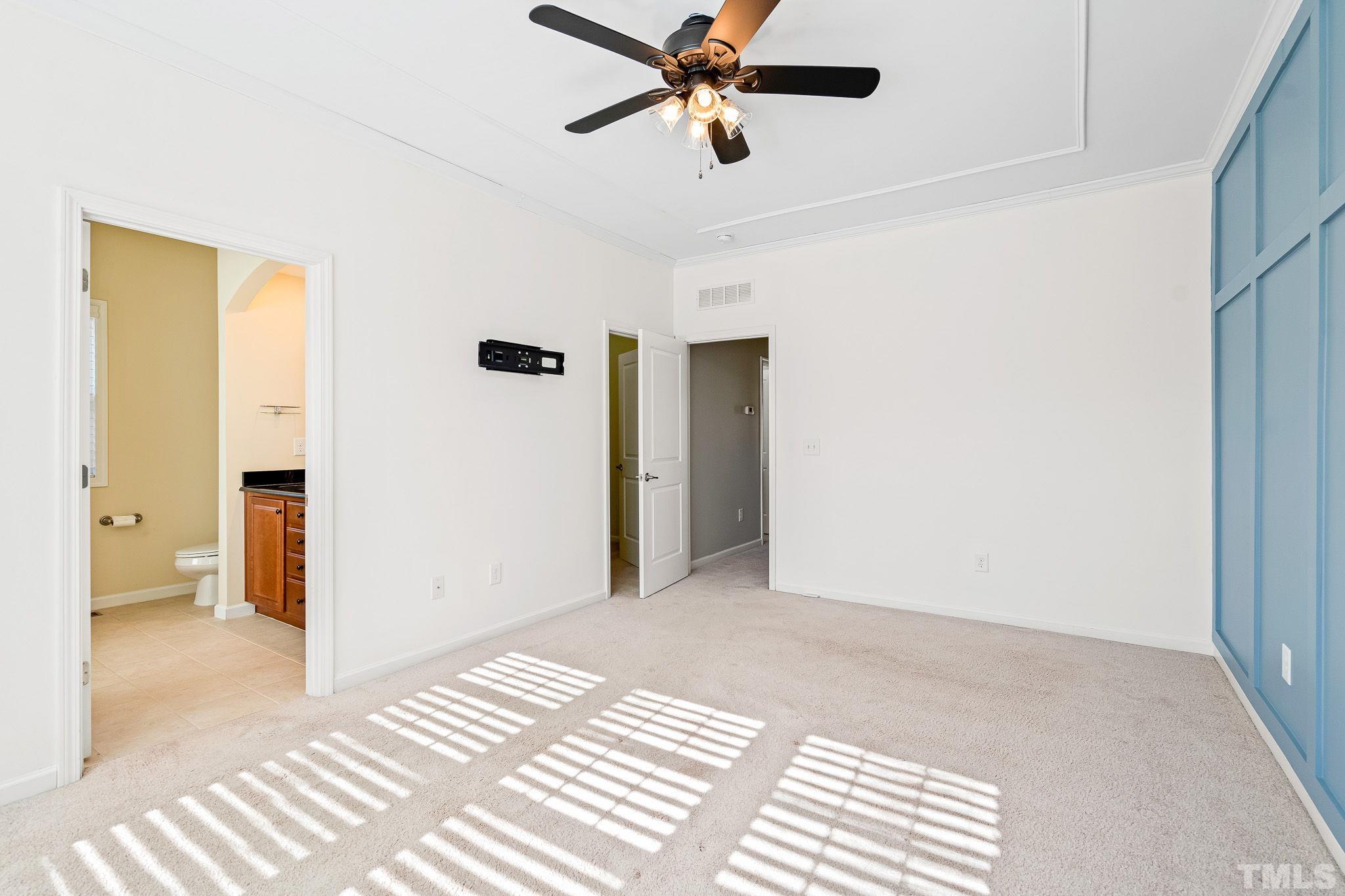 5637 Wade Park Boulevard Raleigh, NC 27607 - Photo 20 of 37 a view of a bedroom with a bed and a chandelier fan