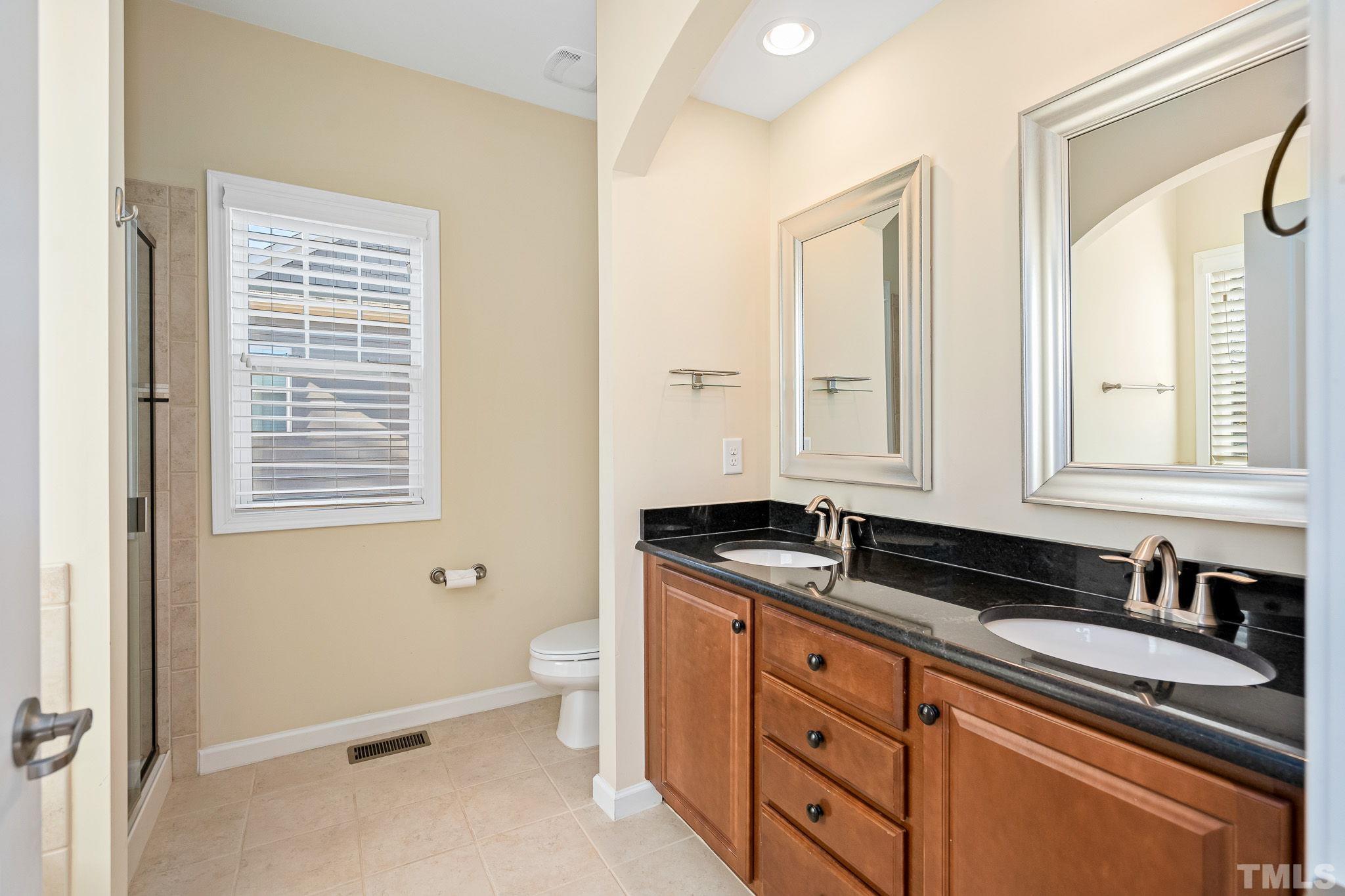 5637 Wade Park Boulevard Raleigh, NC 27607 - Photo 21 of 37 a kitchen with granite countertop cabinets a sink a stove and a window
