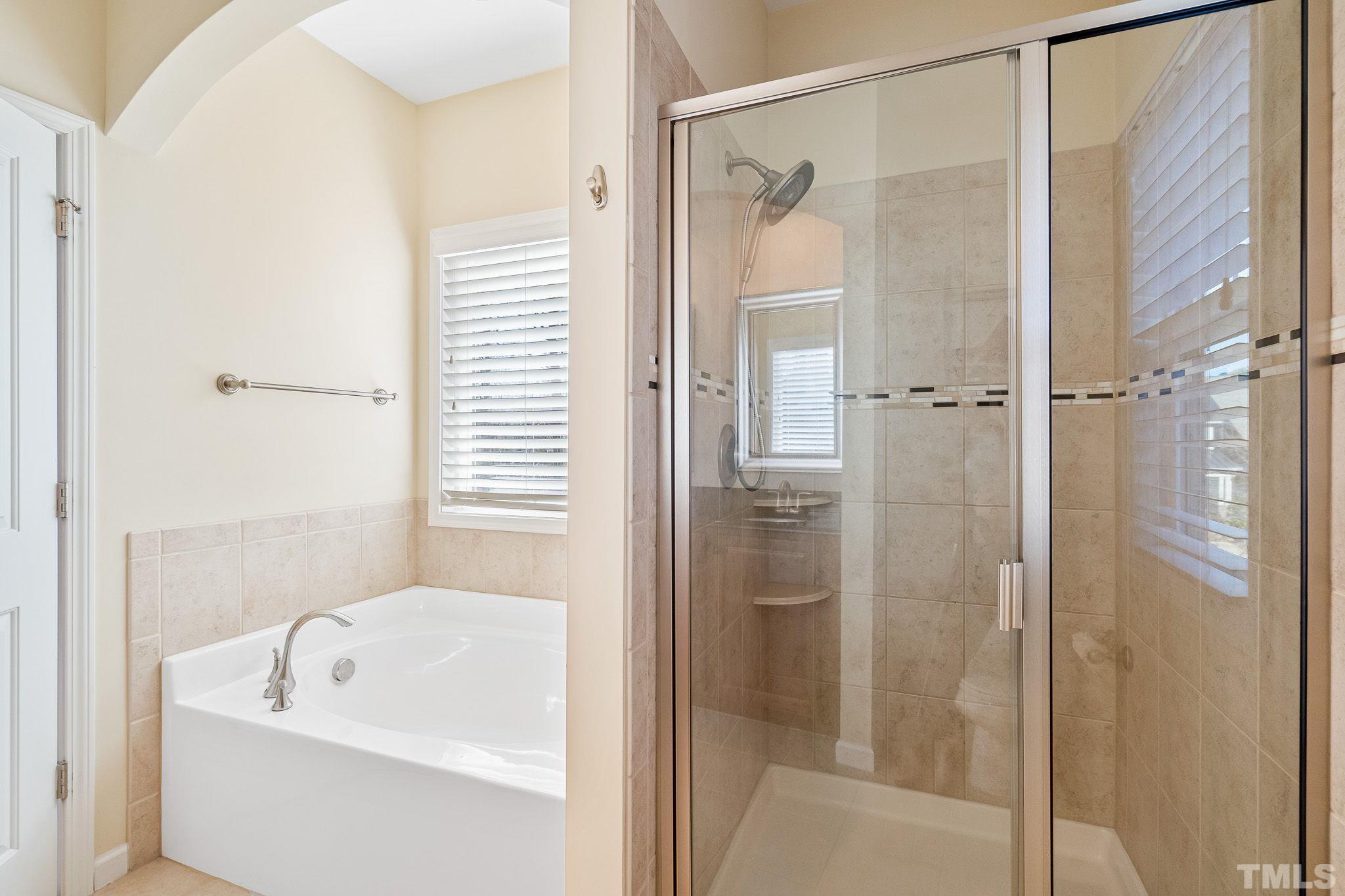 5637 Wade Park Boulevard Raleigh, NC 27607 - Photo 22 of 37 a bathroom with a tub shower and sink