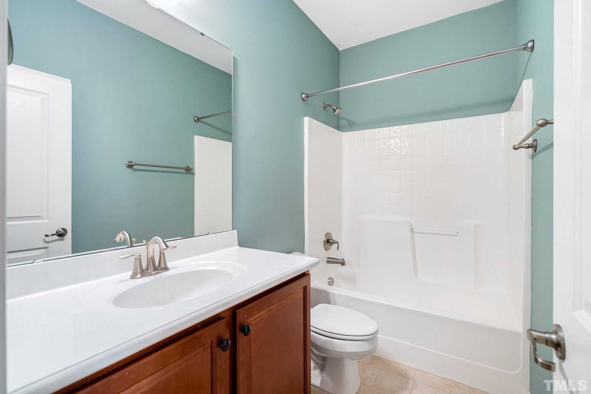 5637 Wade Park Boulevard Raleigh, NC 27607 - Photo 26 of 37 a bathroom with a sink and a mirror