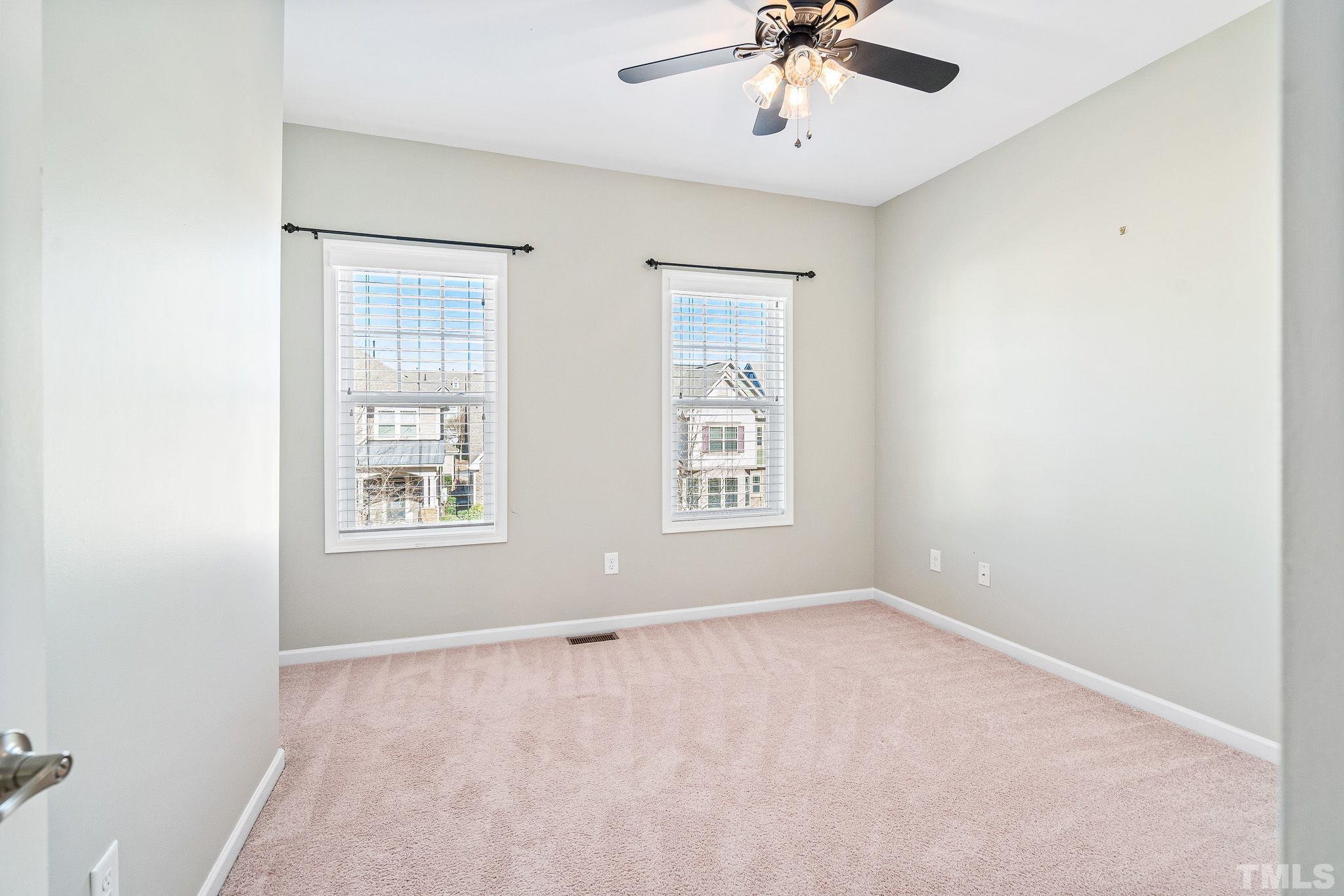 5637 Wade Park Boulevard Raleigh, NC 27607 - Photo 28 of 37 an empty room with windows and fan