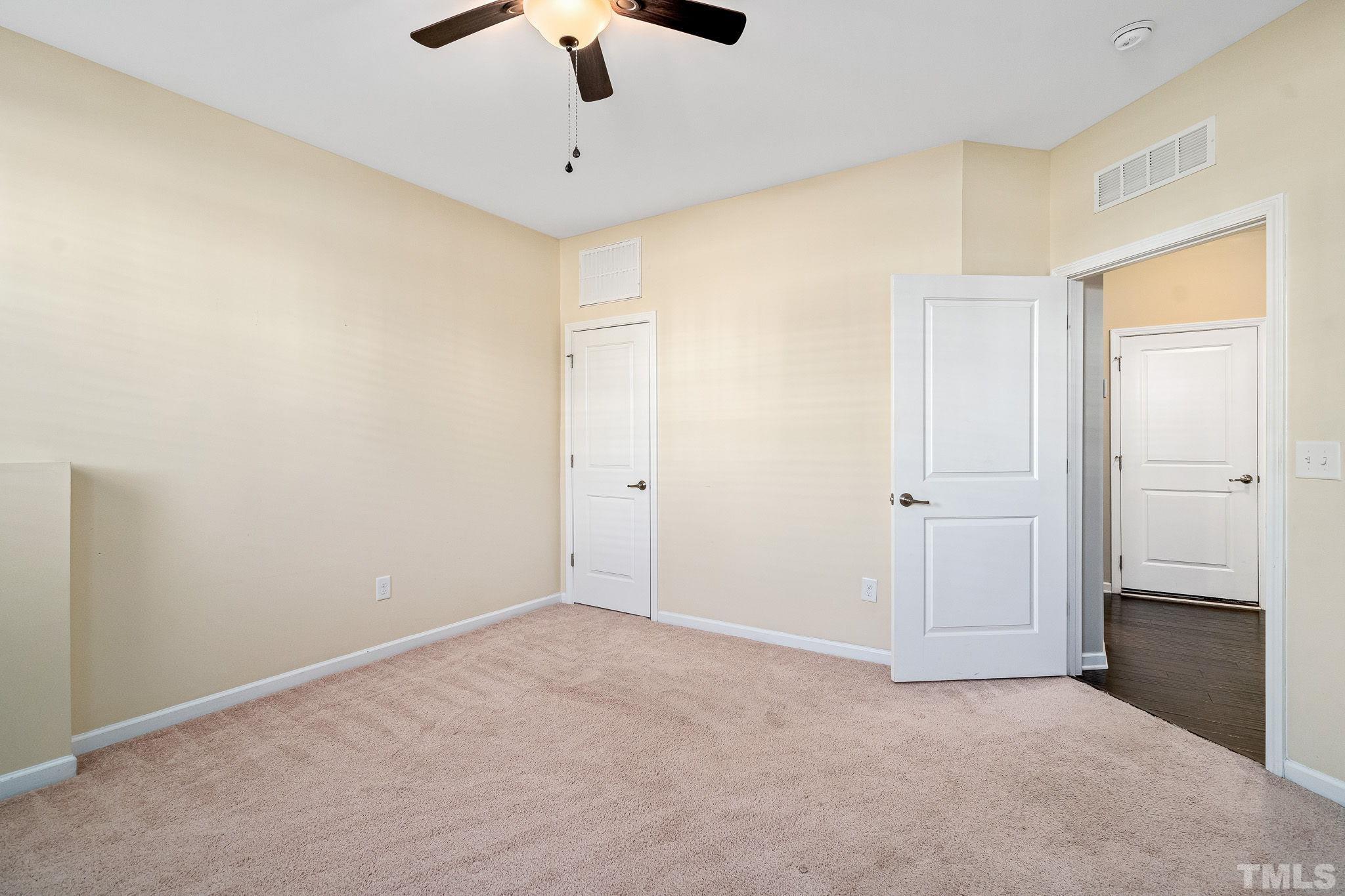 5637 Wade Park Boulevard Raleigh, NC 27607 - Photo 31 of 37 an empty room with chandelier fan