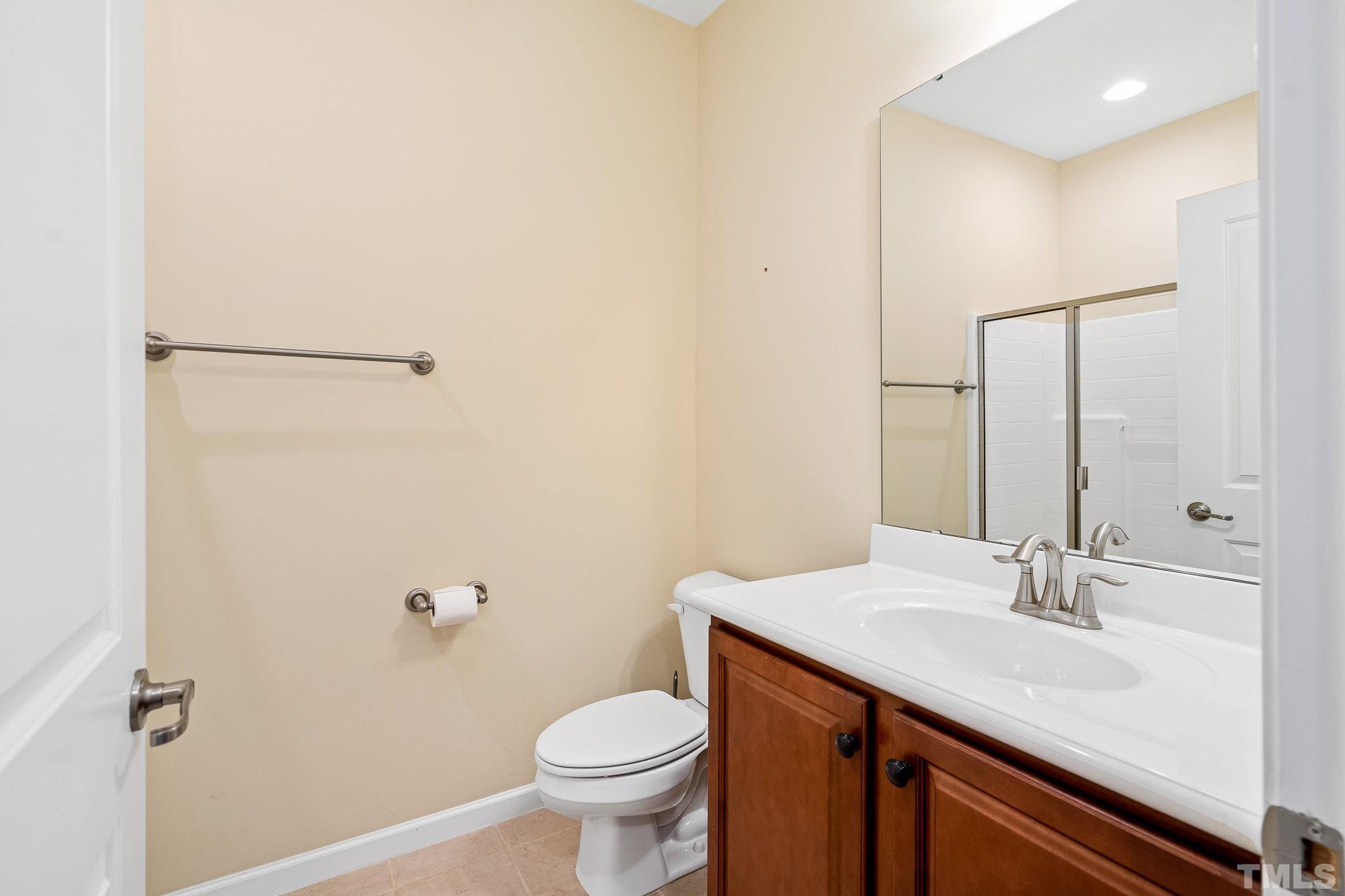 5637 Wade Park Boulevard Raleigh, NC 27607 - Photo 32 of 37 a bathroom with a sink and a mirror