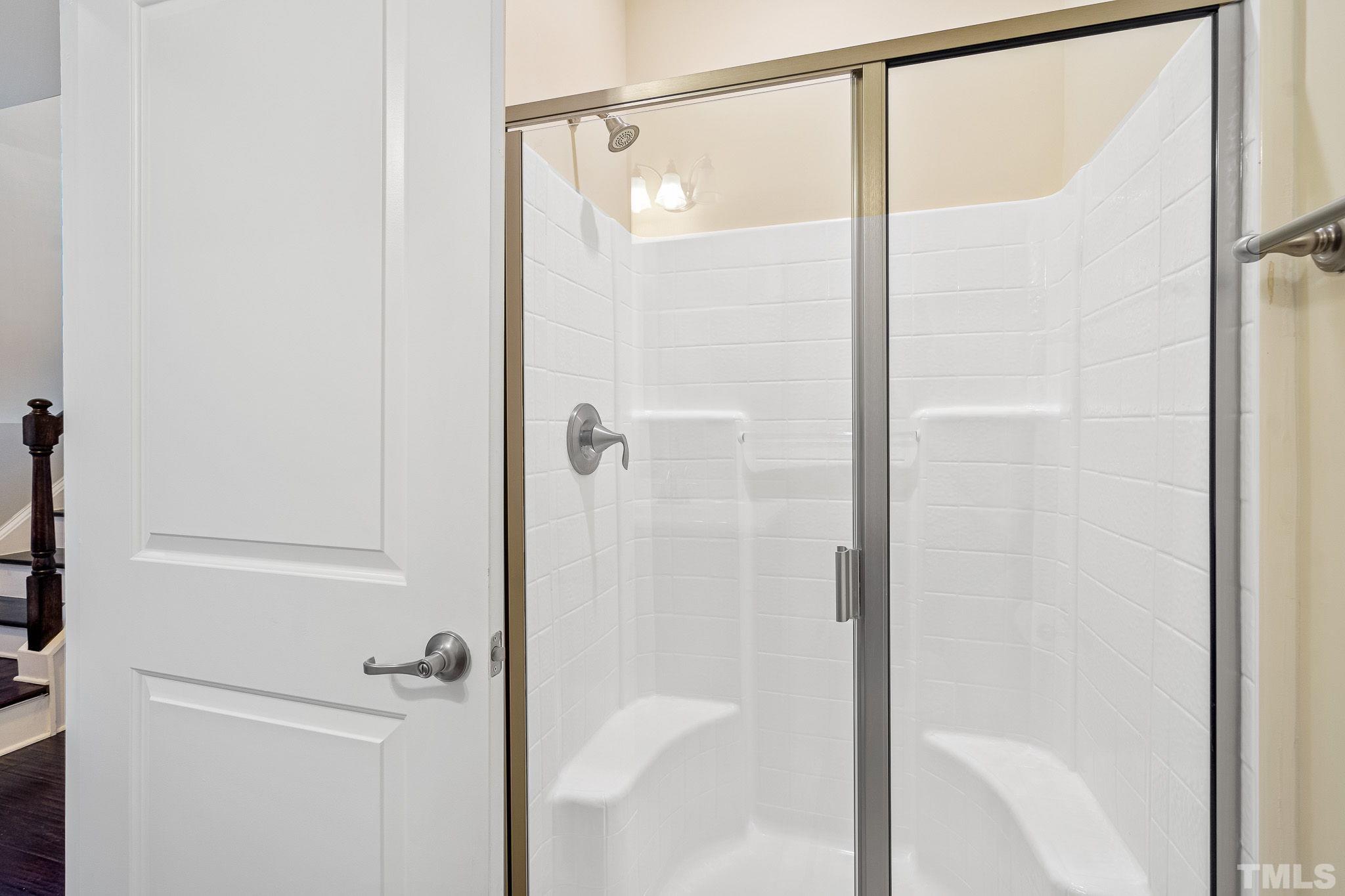 5637 Wade Park Boulevard Raleigh, NC 27607 - Photo 33 of 37 a bathroom with a glass shower door