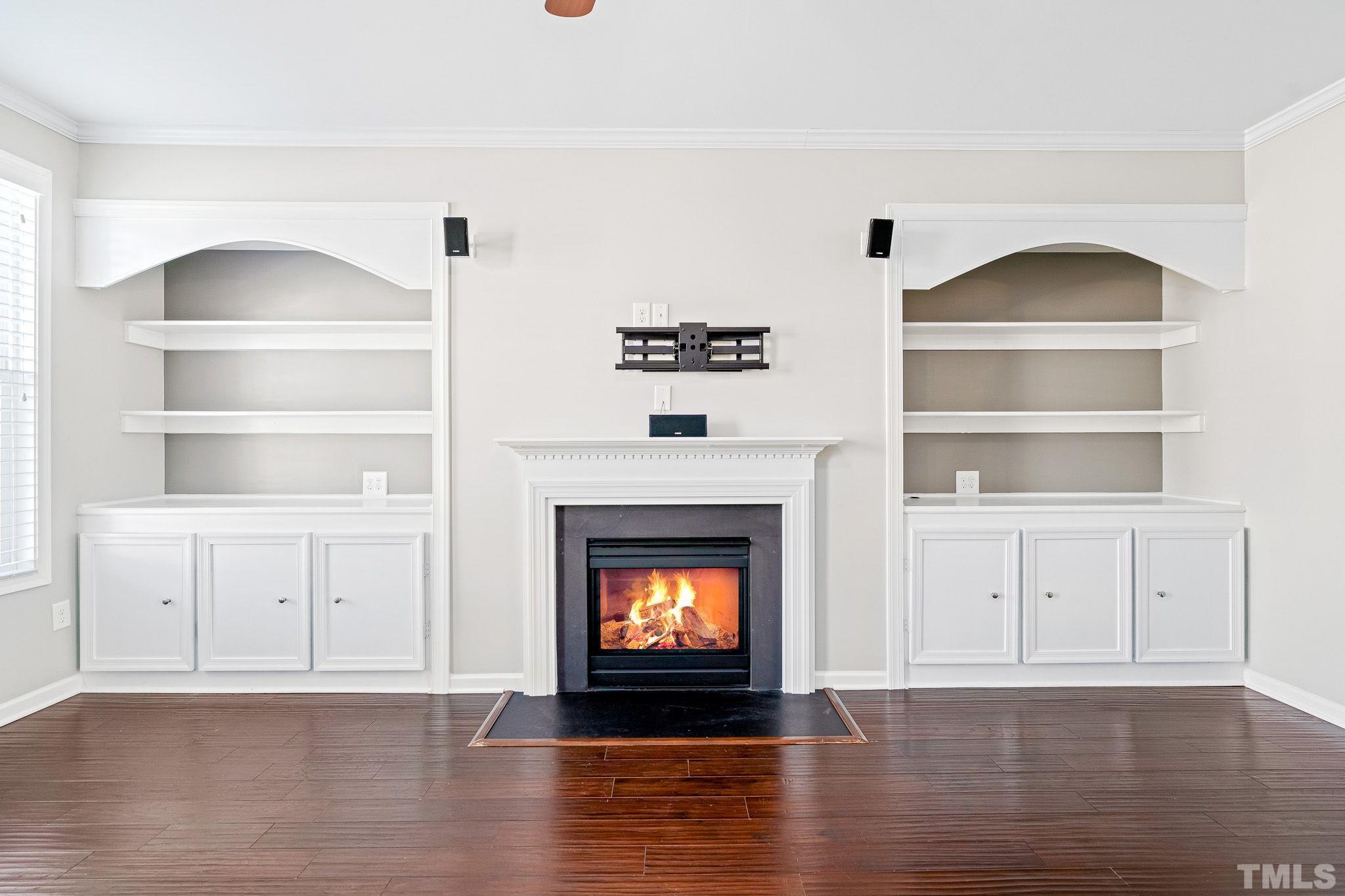 5637 Wade Park Boulevard Raleigh, NC 27607 - Photo 7 of 37 a living room with white cabinets and fireplace