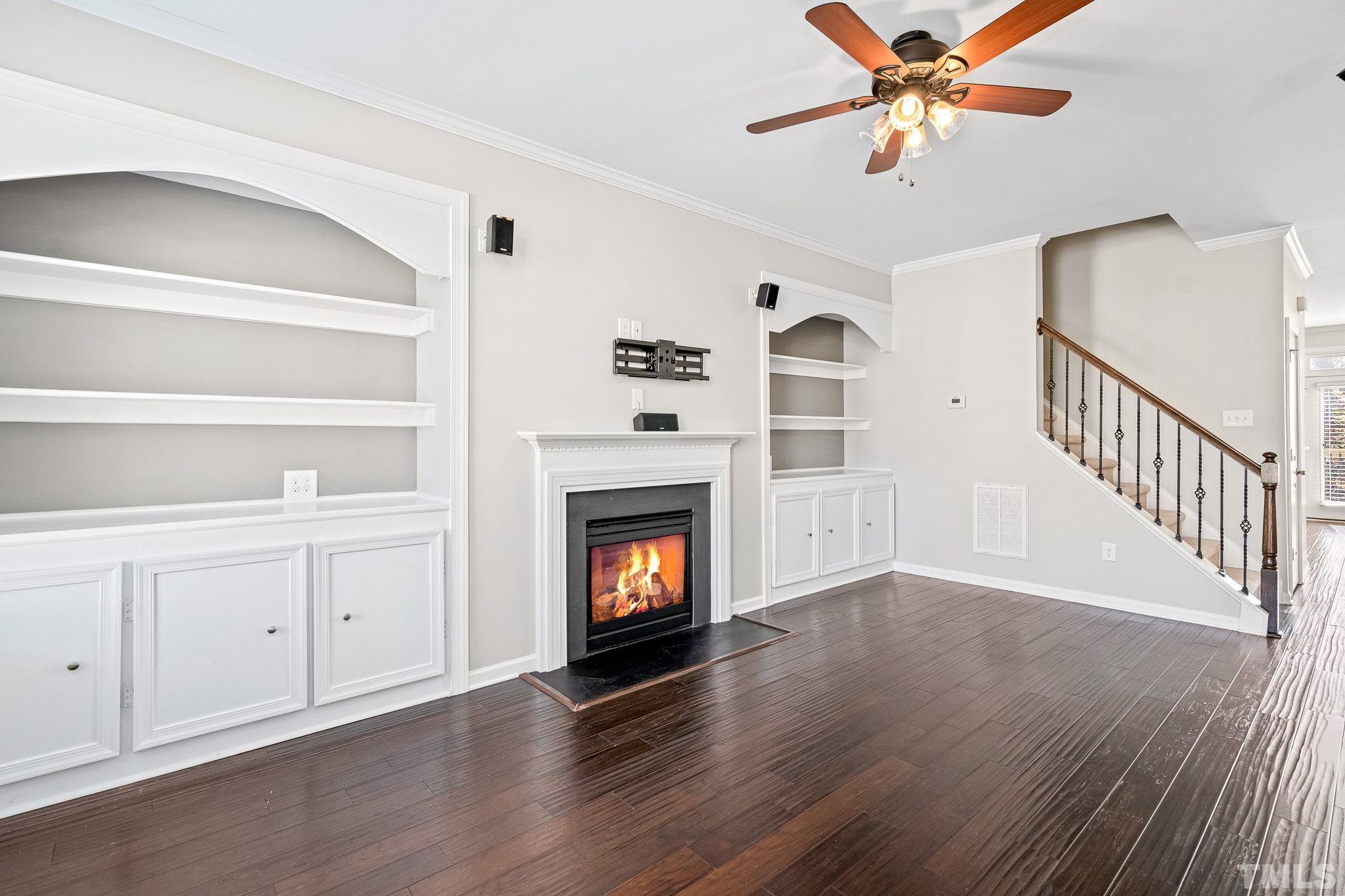 5637 Wade Park Boulevard Raleigh, NC 27607 - Photo 8 of 37 a view of a livingroom with wooden floor and a fireplace