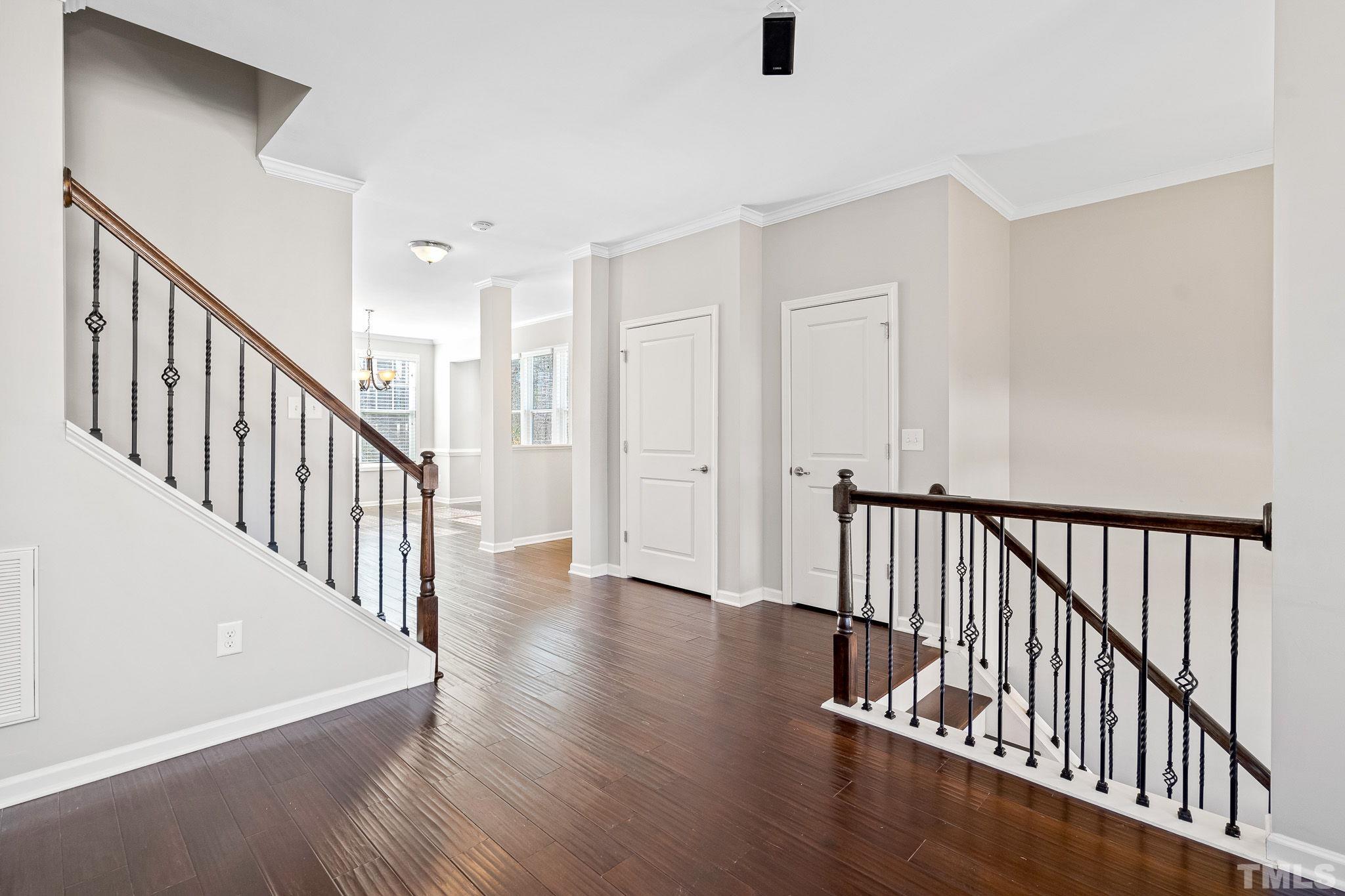 5637 Wade Park Boulevard Raleigh, NC 27607 - Photo 9 of 37 a view of a hallway with wooden floor and staircase