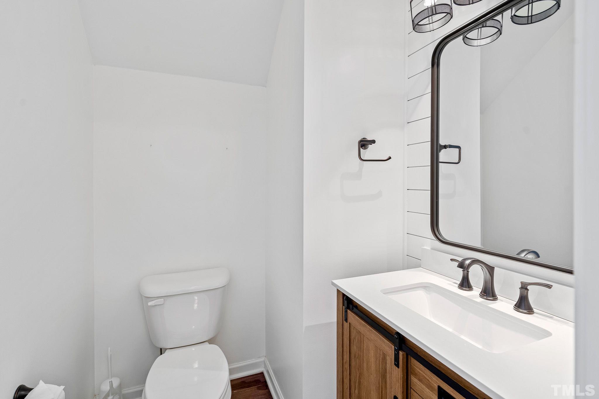 5637 Wade Park Boulevard Raleigh, NC 27607 - Photo 10 of 37 a bathroom with a toilet sink and mirror