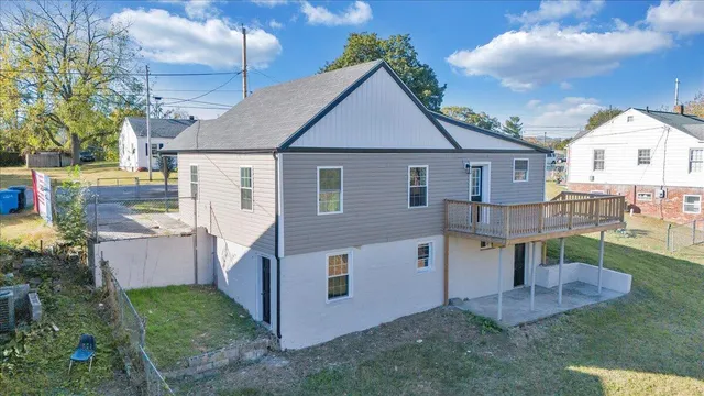 a view of a house with a yard and potted plants