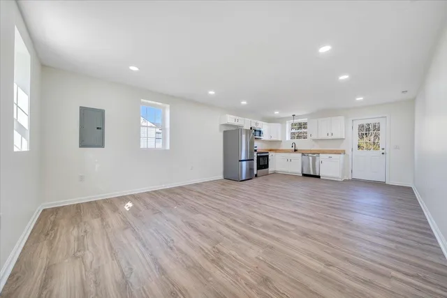 a view of kitchen with furniture and wooden floor