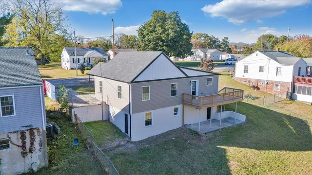 an aerial view of a house with swimming pool and garden