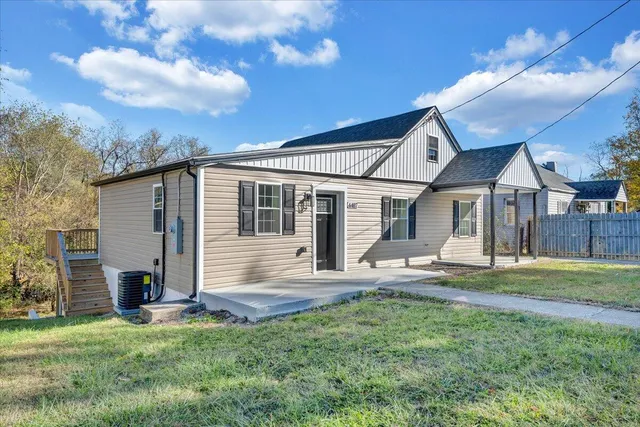 a front view of a house with a garden and yard