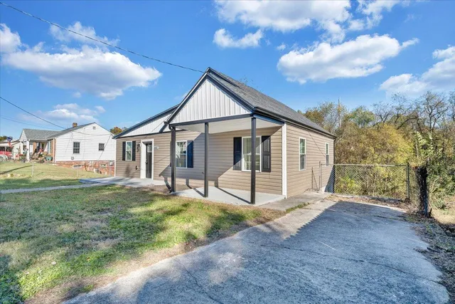 a view of a house with yard and sitting area