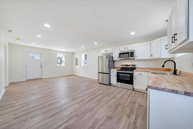 a kitchen with stainless steel appliances granite countertop a stove and a sink