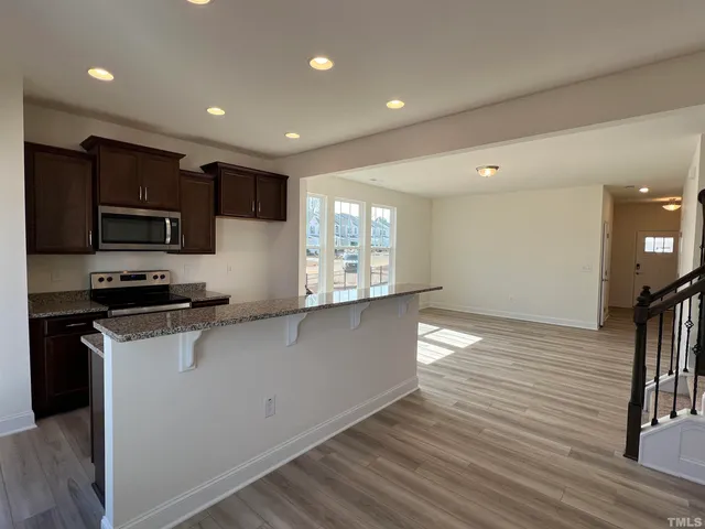 a kitchen with stainless steel appliances a refrigerator sink and microwave