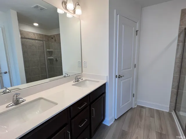 a bathroom with a double vanity sink a and mirror