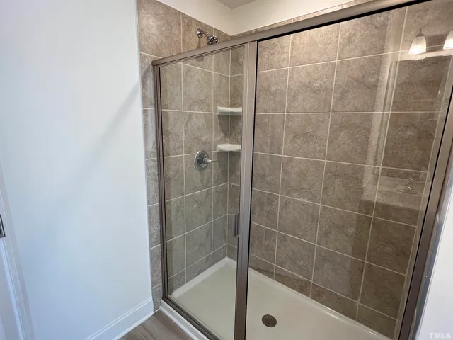 a bathroom with a shower and a sink
