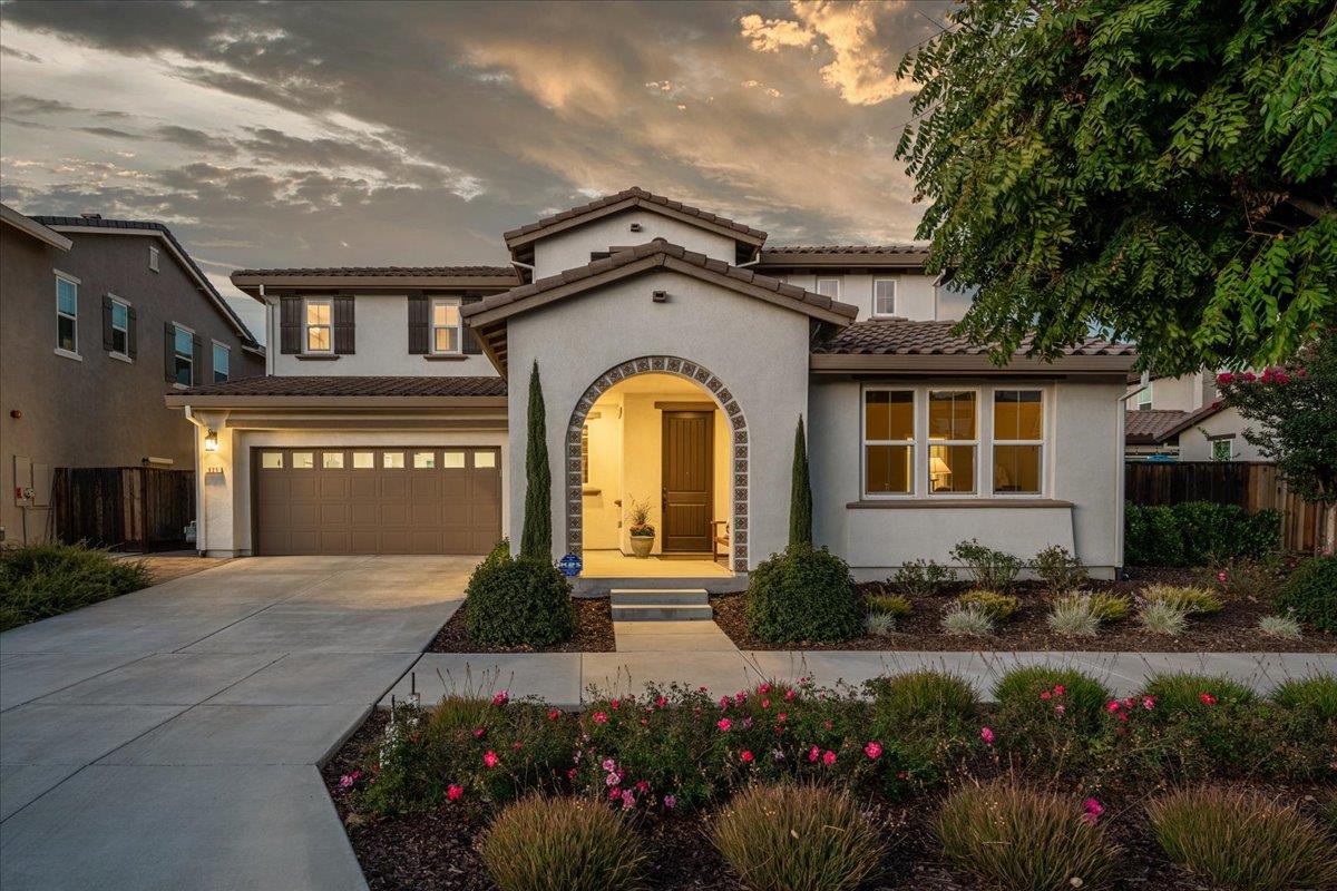a front view of a house with a garden