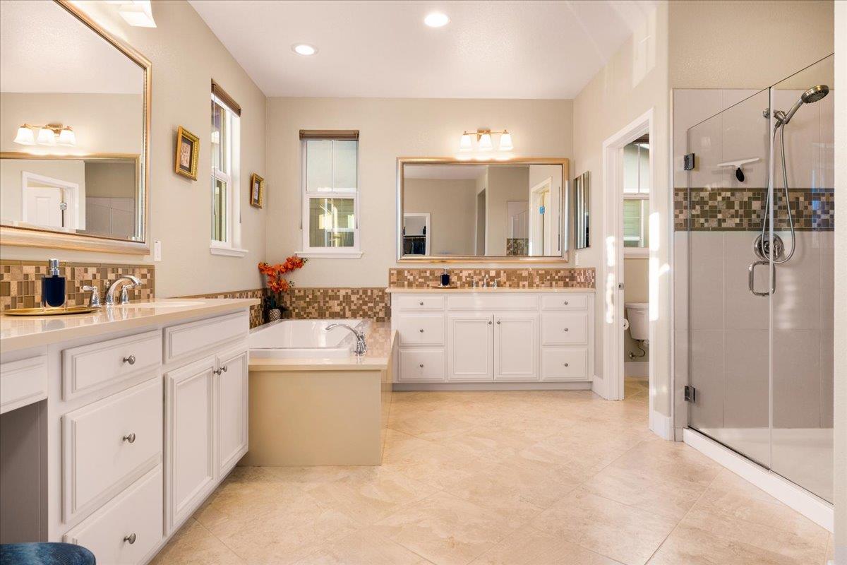 925 Lynx Place Gilroy, CA 95020 - Photo 25 of 49 a large white kitchen with a stove a sink a refrigerator and a refrigerator