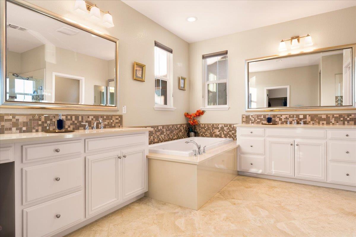 925 Lynx Place Gilroy, CA 95020 - Photo 26 of 49 a spacious bathroom with a granite countertop sink a mirror a and a