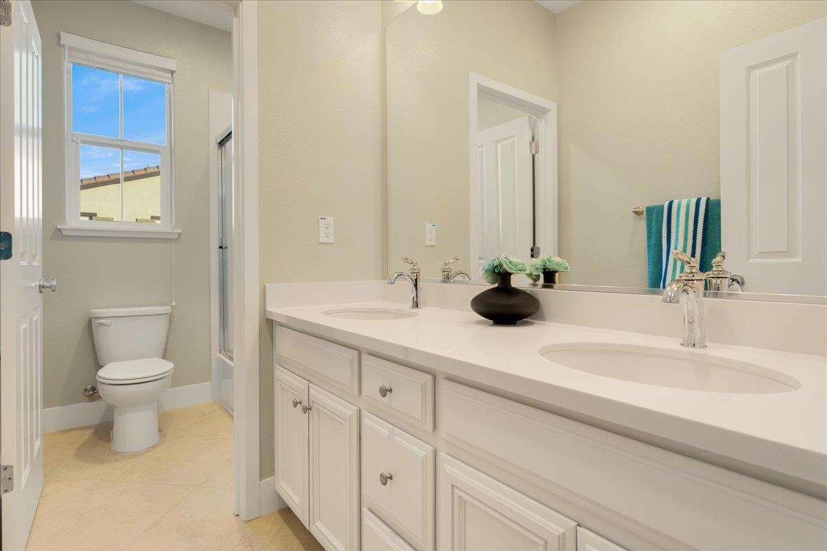 925 Lynx Place Gilroy, CA 95020 - Photo 30 of 49 a bathroom with a double vanity sink and a toilet
