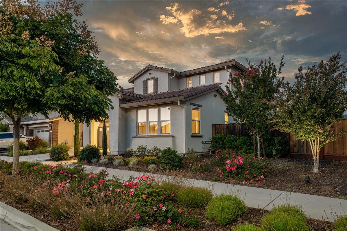 925 Lynx Place Gilroy, CA 95020 - Photo 3 of 49 a front view of a house with a yard and a garden